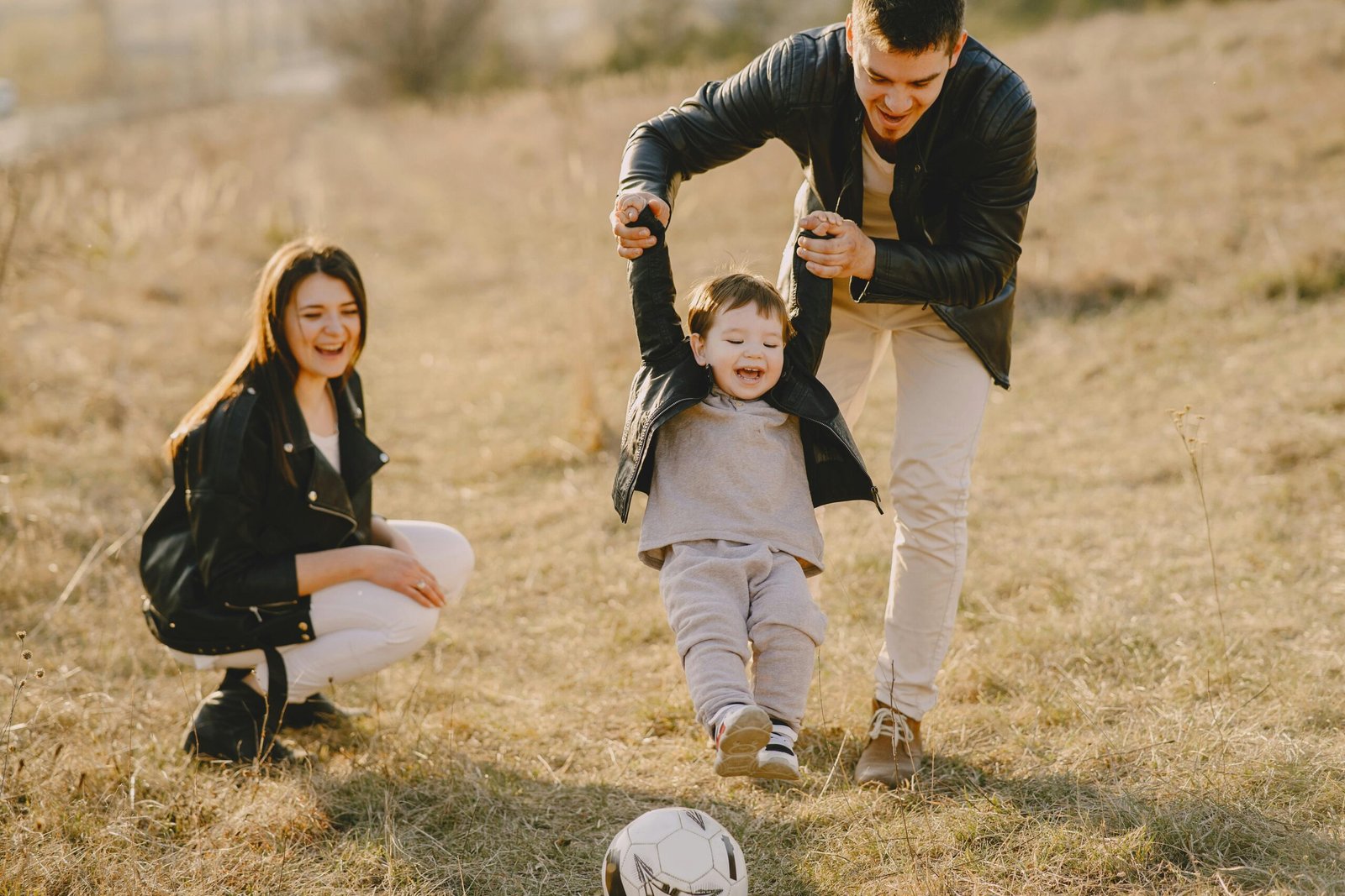 Man and woman playing with child. 