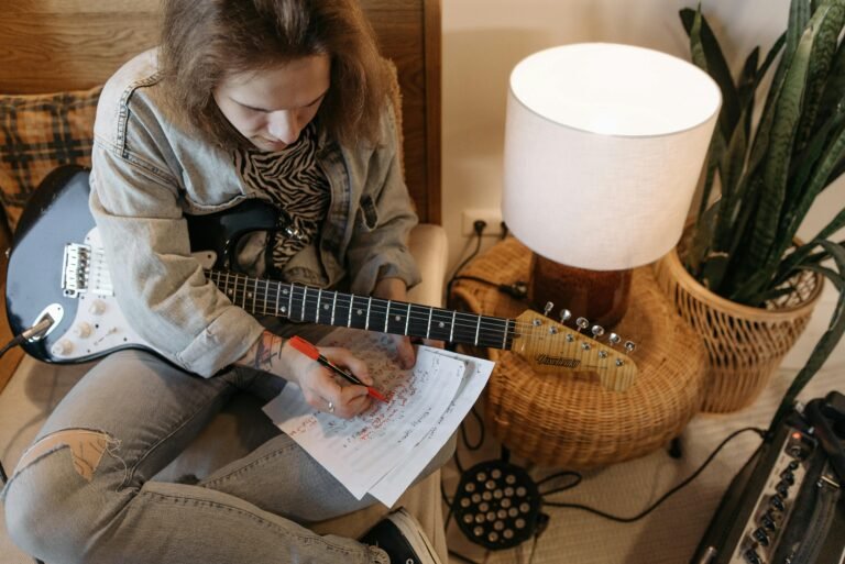 A person sitting on a chair writing music on a sheet of paper. Frank Berrocal, AI (Artificial Intelligence), Music Composition, Innovation, #FrankBerrocal